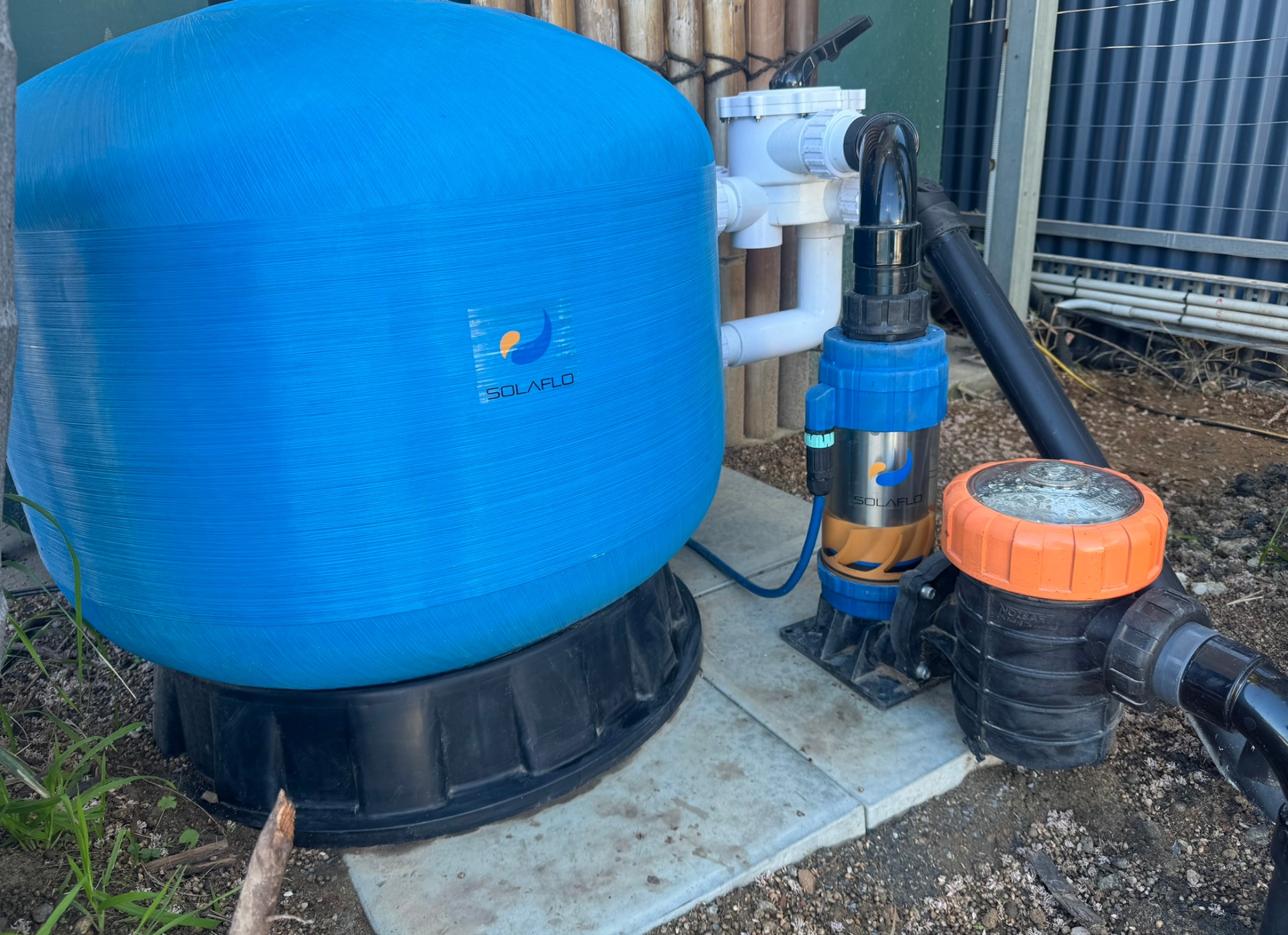 SOLAFLO replacement pump and filter installed on a concrete pad beside a pool